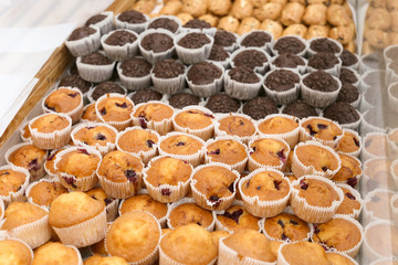 Fresh tasty muffins on display in bakery