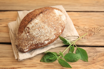 Fresh tasty bread on wooden table