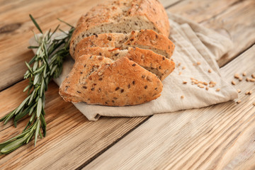 Fresh tasty sliced bread on wooden table