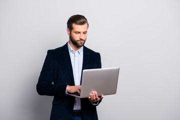 Portrait of smart clever intelligent confident handsome concentrated focused pensive busy banker looking for information news on the internet isolated on gray background copy-space