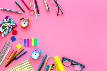 School supplies. Stationery frame with glasses and notebook on pink background top view space for text