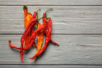 Dry chili peppers on wooden background