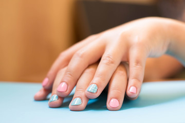 Colorful children's manicure decorations on hand.