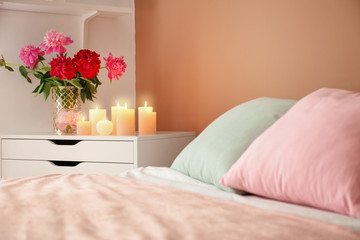 Interior of bedroom with burning candles