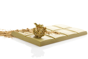 Green cannabis chocolate block with marijuana bud