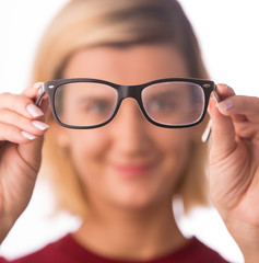 Fototapeta premium People and vision concept - young woman in glasses isolated on white