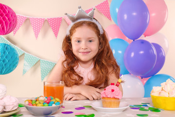 Obraz na płótnie Canvas Cute little girl celebrating Birthday at home