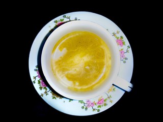 A cup of coffe over white plate