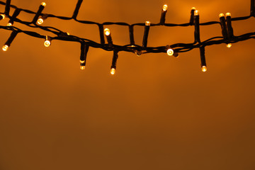 Christmas lights on color background