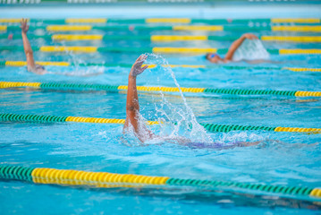 Swimmer swimming competition in the pool is not identifiable