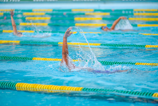 Swimmer swimming competition in the pool is not identifiable