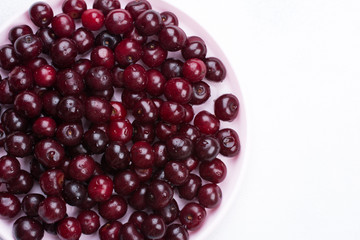 Concept summer. Scattered fresh red ripe cherry on a white concrete background. Design Copy Space Top View Flat Lay Close-up.