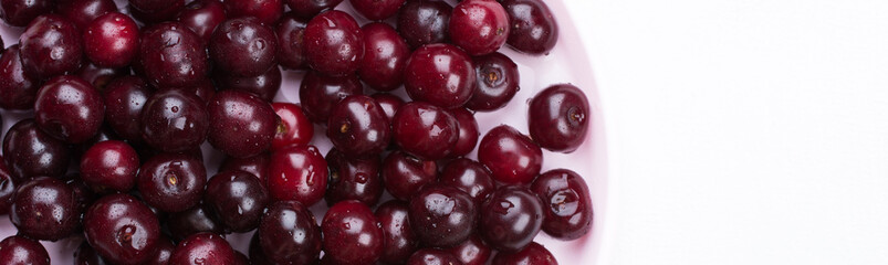 Banner Concept summer. Scattered fresh red ripe cherry on a white concrete background. Design Copy Space Top View Flat Lay Close-up.