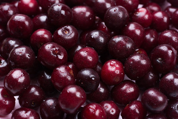 Concept summer. Close up of scattered of ripe cherries. Large collection of fresh red cherries. Ripe cherries background. Design Copy Space Top View Flat Lay Close-up.