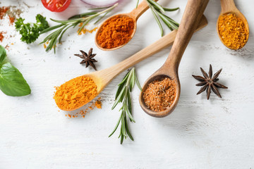 Various spices with herbs on wooden background
