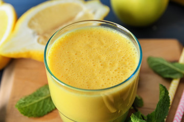 Glass of fresh tasty smoothie on table, closeup
