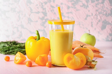 Glass of fresh tasty smoothie and ingredients on table
