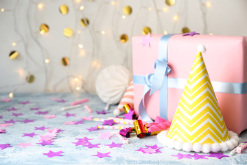 Birthday party items with gift box on table