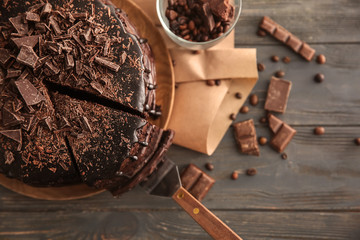 Plate with delicious chocolate cake on wooden table