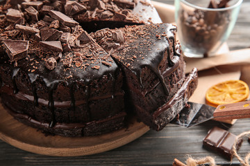 Plate with delicious chocolate cake on wooden table, closeup