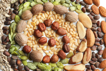 Composition with different nuts on white background, top view