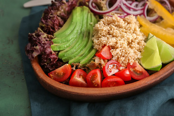 Plate with quinoa salad on table, closeup