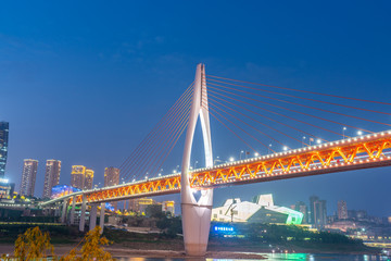 Fototapeta na wymiar The qianshimen bridge at night is located in chongqing, China