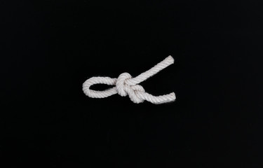 sea rope knot on a black isolated background