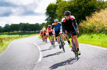  Cyclists racing on country roads on a sunny day in the UK. © Duncan Andison