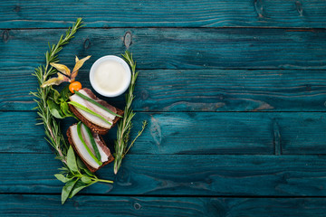 Sandwich with lard and onions. Ukrainian cuisine. On a wooden background. Top view. Copy space.