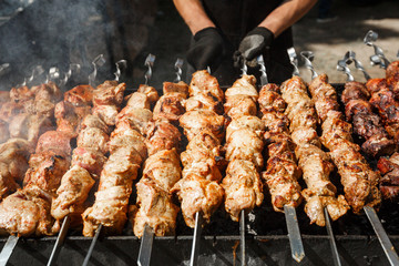 Man cooking grilled barbecue meet on skewer