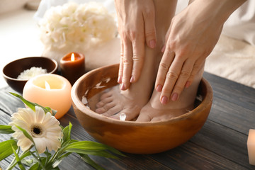 Young woman undergoing spa pedicure treatment in beauty salon