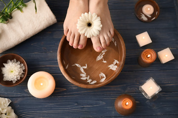 Young woman undergoing spa pedicure treatment in beauty salon