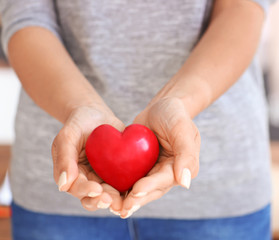 Woman holding red heart, closeup.  Health care concept