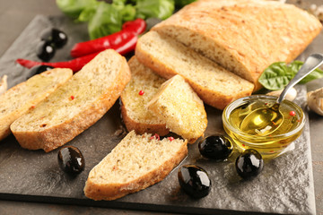 Olive oil with sliced bread on slate plate