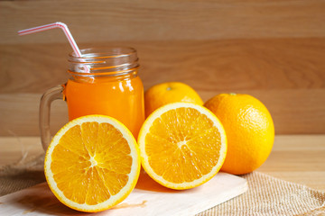 Orange and orange juice on wooden background