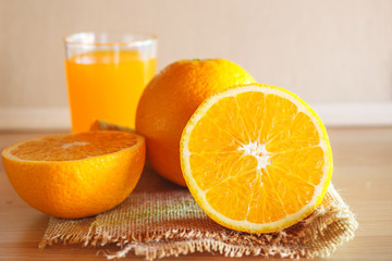 Orange and orange juice on wooden background