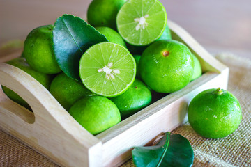Fresh Citrus lime fruit in wooden box