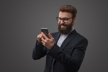 Man in suit using phone in studio