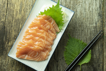 salmon sashimi on wooden background