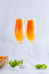 Italian Bellini alcoholic cocktail made from sweet ripe melon with basil flavor. Ideal drink for snacks