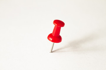 Red pushpin on white background