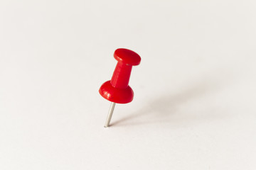 Red pushpin on white background
