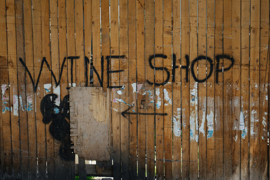 Old wooden fence with wine shop sign