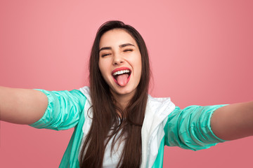 Young woman showing tongue in studio