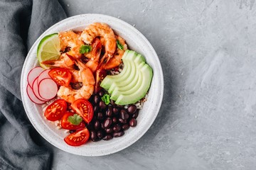 Spicy Shrimp Burrito Buddha Bowl with wild rice, tomatoes and radish, black beans and avocado