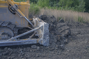 process of operation of a modern bulldozer on a construction site