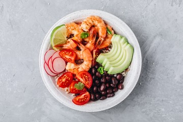 Spicy Shrimp Burrito Buddha Bowl with wild rice, tomatoes and radish, black beans and avocado