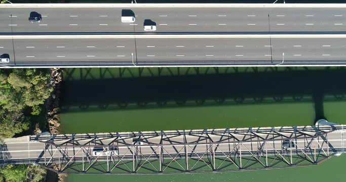 Side sliding looking top down to Motorway one M1 bridge over Hawkesbury river on NSW Central coast in parallel panning.
