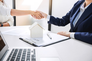 Handshake after good cooperation, Real estate broker residential agent shaking hands with customer after good deal agreement house rent listing contract